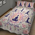 Floral yoga quilt blanket displayed at an angle with purple yoga silhouettes and lotus artwork