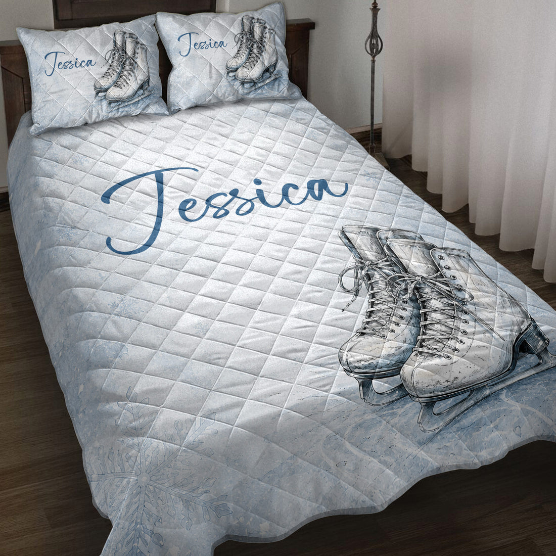 Ice skating quilt blanket displayed on a bed with figure skates artwork and pale blue winter details