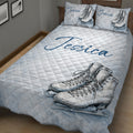 Close bedroom view of an ice skating quilt blanket with large figure skate artwork and winter details