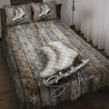 Ice skating quilt blanket displayed on a bed with white figure skates, wood plank artwork, and snowflakes