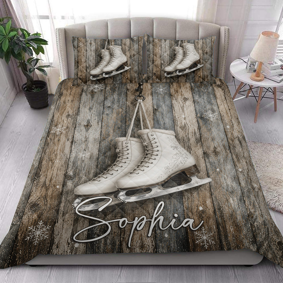 Ice skating quilt blanket styled on a bedroom bed with large white figure skates and snowflake accents