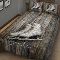Close view of ice skating quilt bedding with white figure skates, rustic wood artwork, and snowflakes