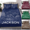 Navy ski quilt bedding styled on a bed with mountain artwork and alternate color designs