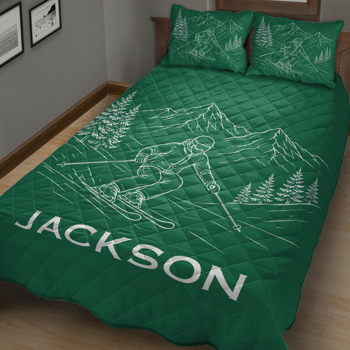 Green ski quilt blanket displayed in a bedroom with skier, mountain, and evergreen artwork