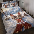 Skiing quilt blanket displayed on a bed with snowy mountains, crossed skis, and ski poles