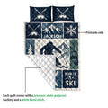 Skiing quilt showing the printed front and quilted white reverse with mountain, skier, and ski equipment artwork