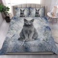 Russian Blue cat quilt blanket styled in a bright bedroom with matching cat artwork on the pillows