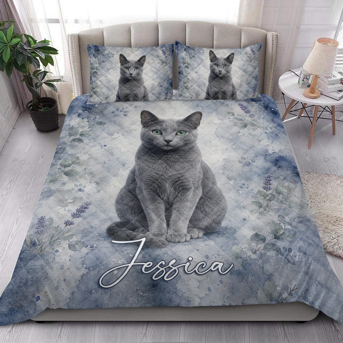 Russian Blue cat quilt blanket styled in a bright bedroom with matching cat artwork on the pillows