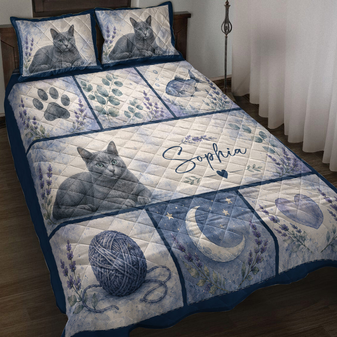 Russian Blue cat quilt blanket displayed on a bed with lavender flowers, paw prints, fish, hearts, and moon artwork