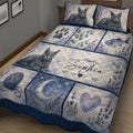 Close view of Russian Blue cat quilt bedding with cat portraits, lavender branches, yarn, fish, and blue moon artwork