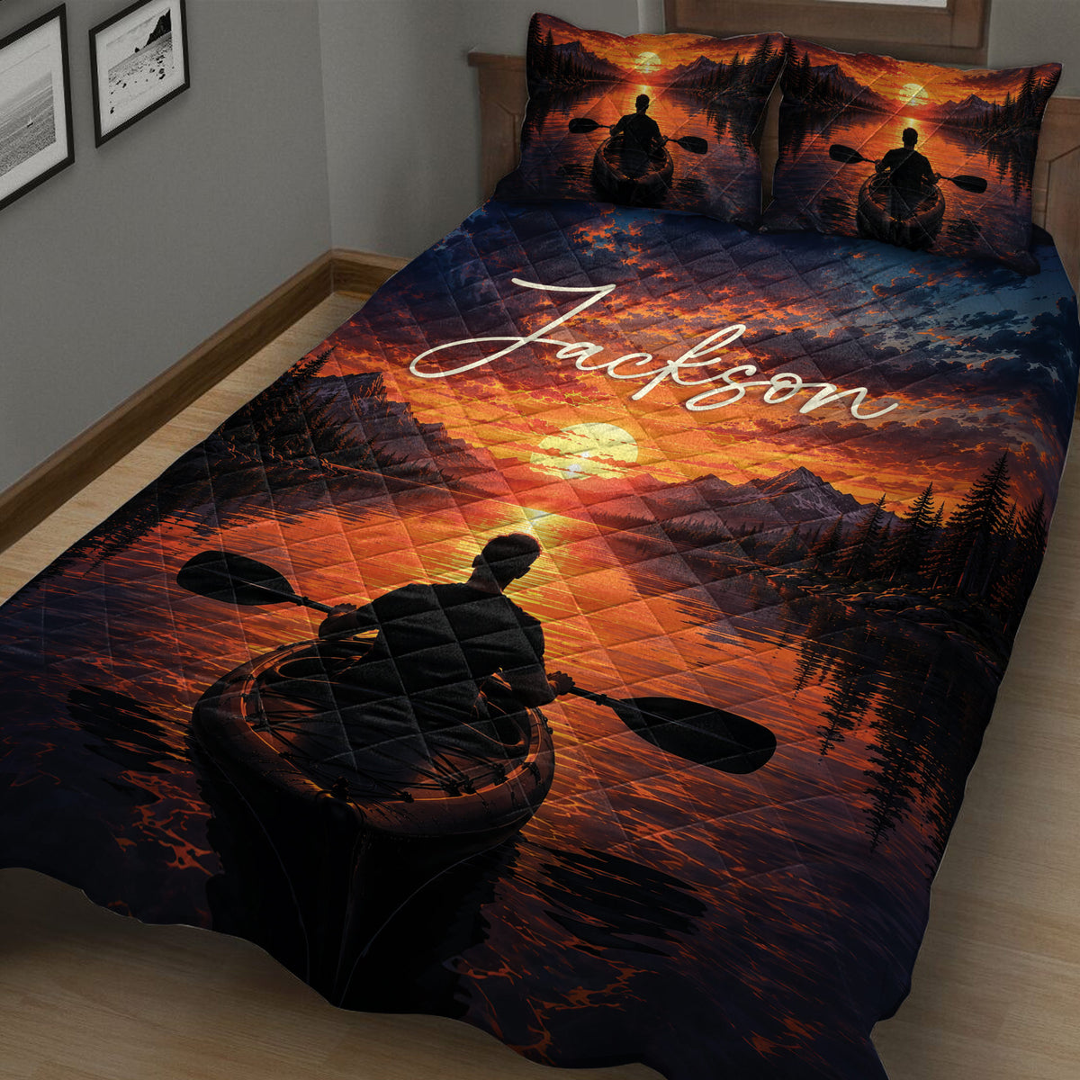 Kayak quilt blanket displayed at an angle with dramatic sunset mountains, water, and paddling artwork