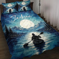 Kayak quilt blanket displayed on a bed with mountain lake artwork, moonlit water, evergreen trees, and a paddler