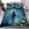 Kayak quilt blanket styled on a bedroom bed with vivid blue water, fish, and paddling artwork
