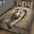 Close bedroom view of a whippet quilt blanket with tan cracked-stone artwork and matching pillows