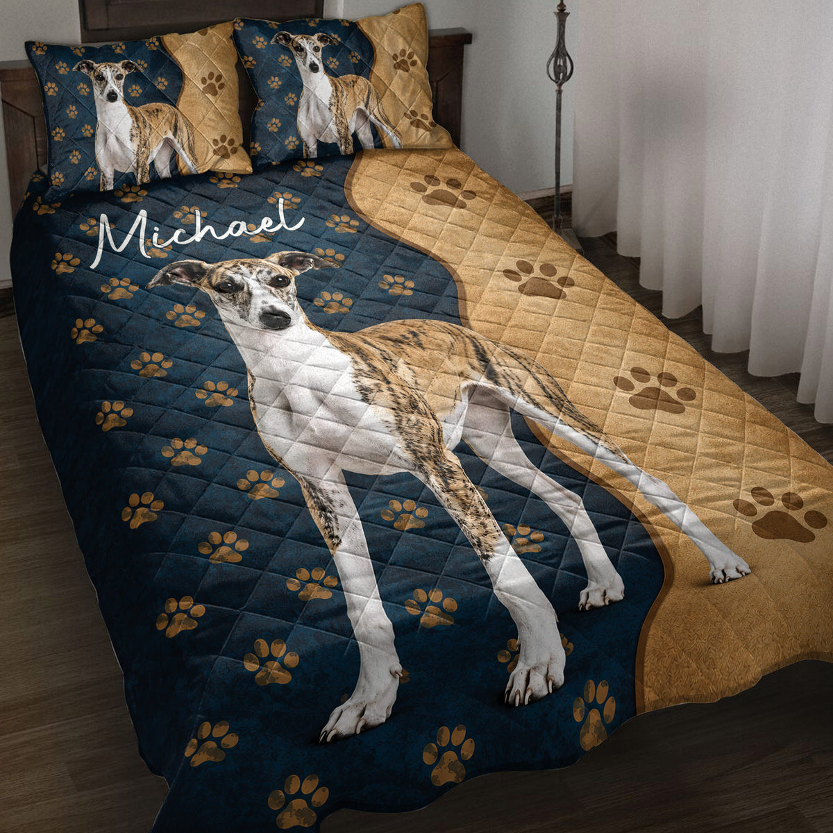 Whippet quilt blanket displayed on a bed with navy and tan paw print artwork