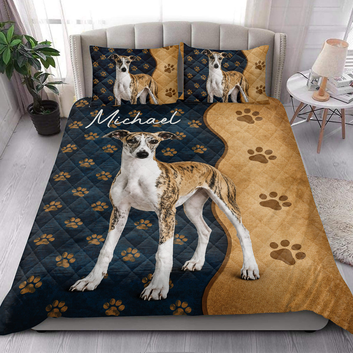Whippet quilt bedding styled on a bright bedroom bed with navy, tan, and paw print details