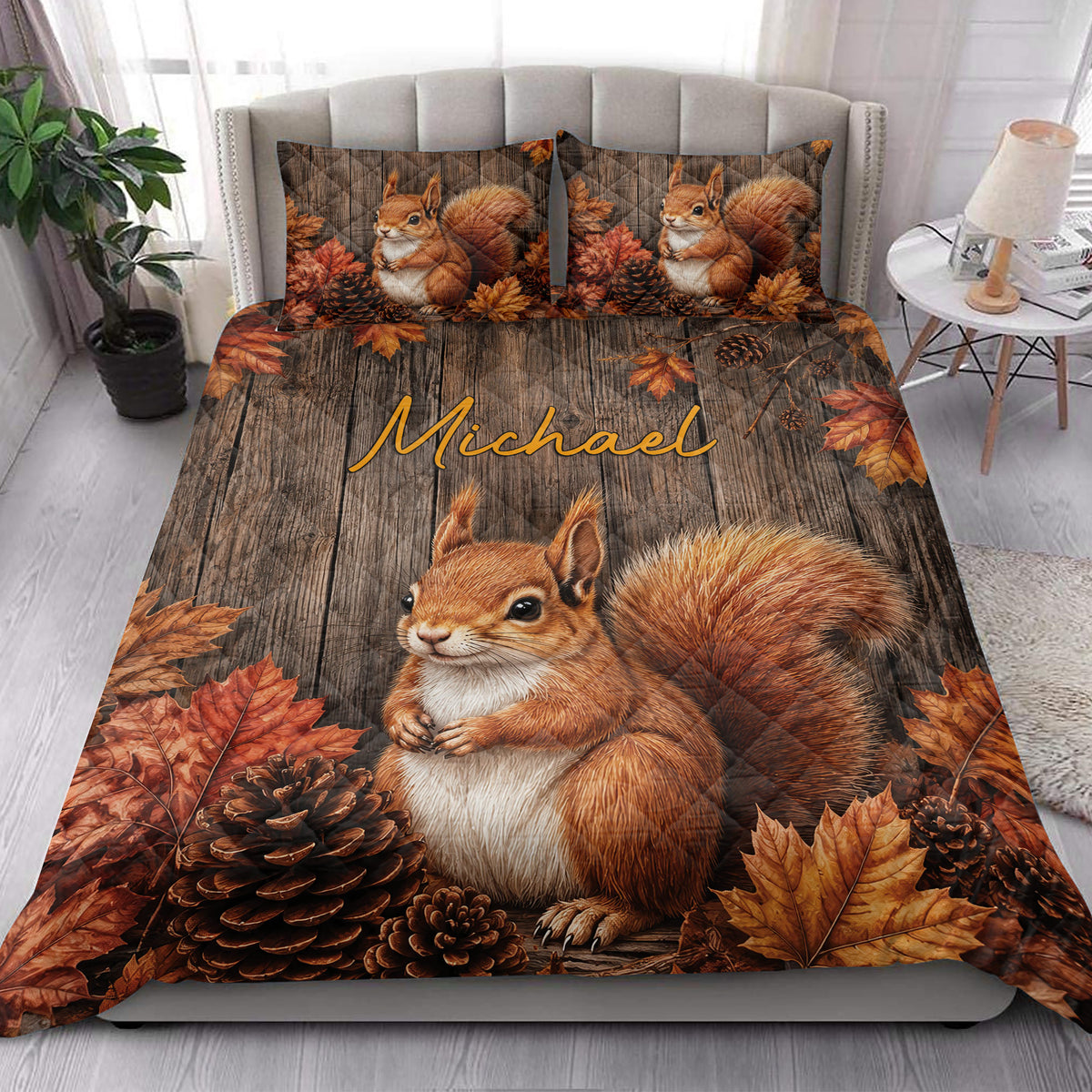 Squirrel quilt blanket styled on a bright bedroom bed with woodland autumn artwork