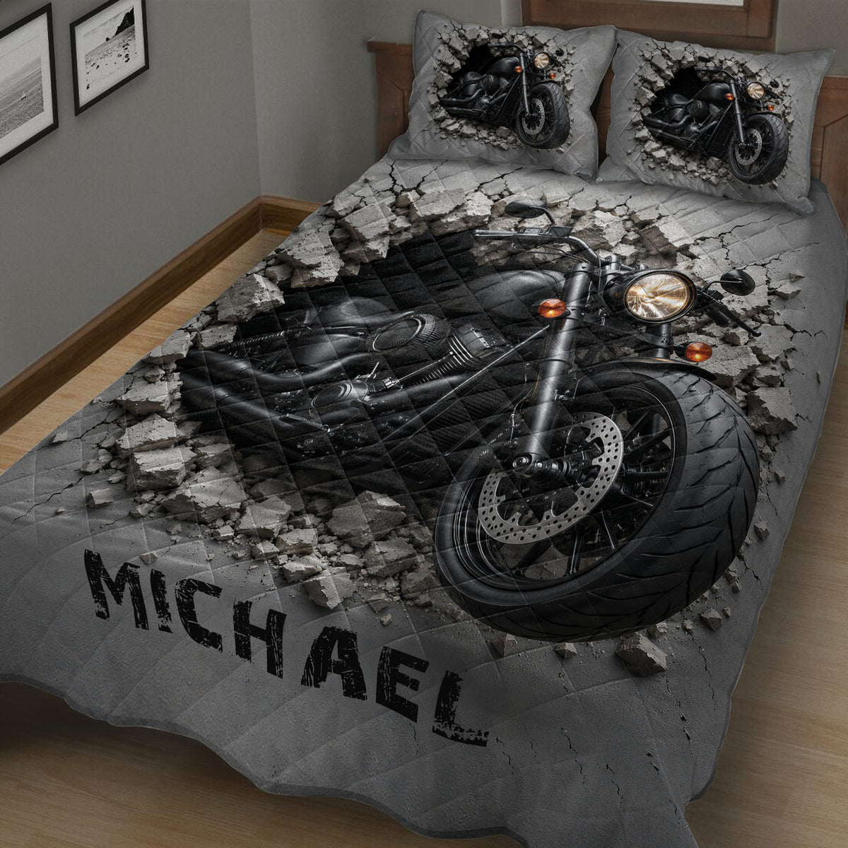 Close bedroom view of a gray biker quilt with large black motorcycle artwork and matching motorcycle pillow designs