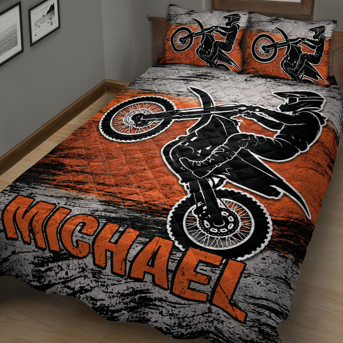 Angled bedroom view of a motocross quilt blanket featuring dirt bikes and rider silhouettes