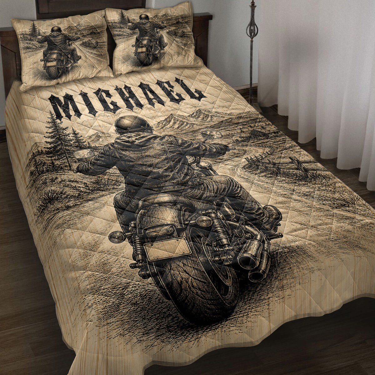 Biker quilt blanket displayed on a bed with motorcycle rider, mountain road, forest, and rustic black artwork