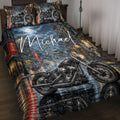 Biker quilt blanket displayed on a bed with motorcycles, rainy city streets, skull artwork, and dark urban colors