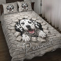 Dalmatian quilt bedding set displayed on a bed with spotted dogs breaking through a stone wall