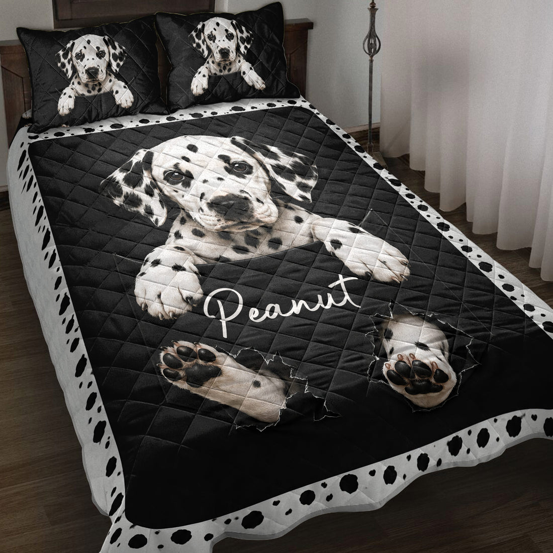 Black and white Dalmatian dog quilt blanket styled on a bedroom bed with spotted border