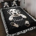 Black and white Dalmatian dog quilt blanket styled on a bedroom bed with spotted border