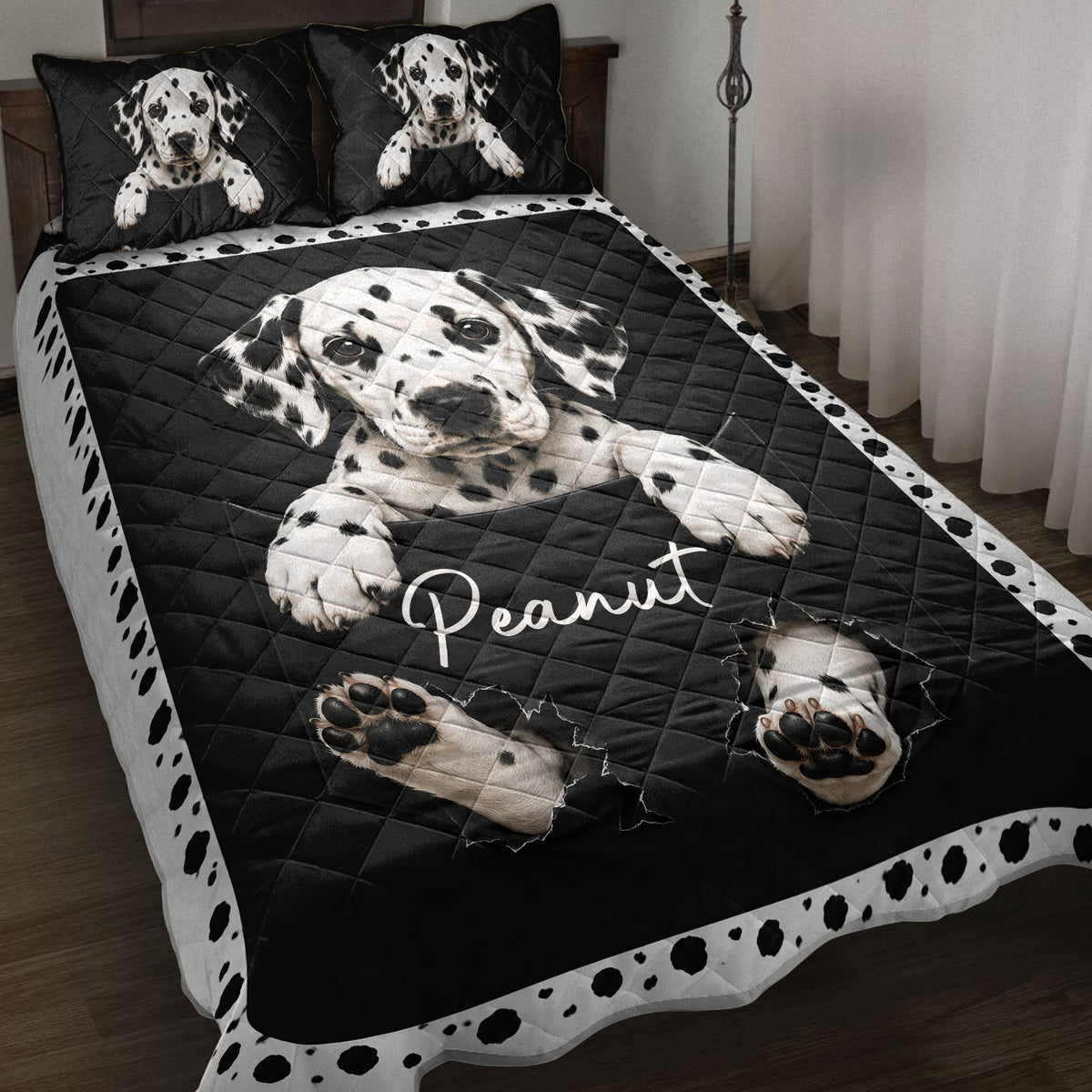 Black and white Dalmatian dog quilt blanket styled on a bedroom bed with spotted border