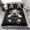 Dalmatian dog quilt bedding styled in a bright bedroom with matching black and white dog artwork