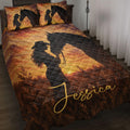 Cowgirl and black horse silhouette quilt blanket displayed on a bed with warm western sunset colors