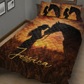 Close-up cowgirl and horse quilt blanket displayed across a rustic bedroom bed
