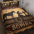 Cowgirl quilt blanket displayed on a bed with horse silhouettes, horseshoes, rustic wood textures, and Southwestern patterns