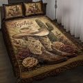Cowgirl quilt blanket styled on a bed with cowboy boots, hat, cactus, roses, and ornate Western artwork