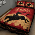 Close view of cowgirl quilt blanket featuring a horseback rider, red desert landscape, cacti, and rustic Western artwork