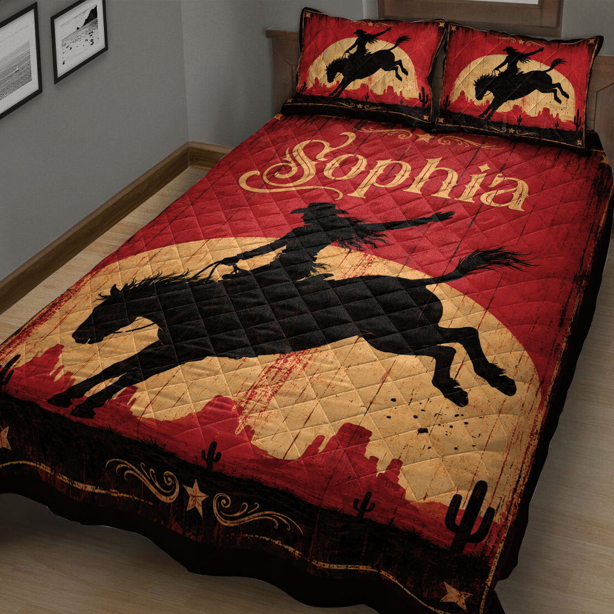 Close view of cowgirl quilt blanket featuring a horseback rider, red desert landscape, cacti, and rustic Western artwork