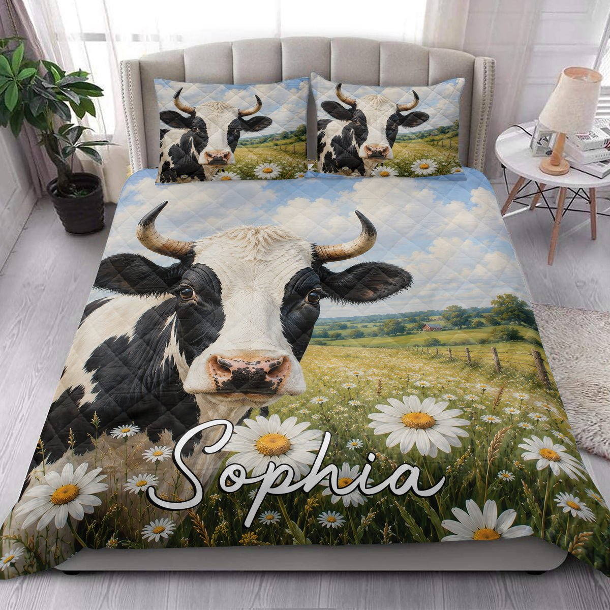 Dairy cow quilt bedding styled on a bedroom with a close-up cow, daisies, meadow, and countryside artwork