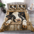 Dairy cow quilt bedding styled in a bright bedroom with rustic wood framing and black-and-white cow artwork