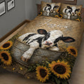 Close view of a dairy cow quilt blanket with sunflower borders and rustic farmhouse artwork
