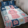 Nurse quilt blanket displayed on a bed with caduceus symbols, medical tools, scrubs, gloves, and heart artwork