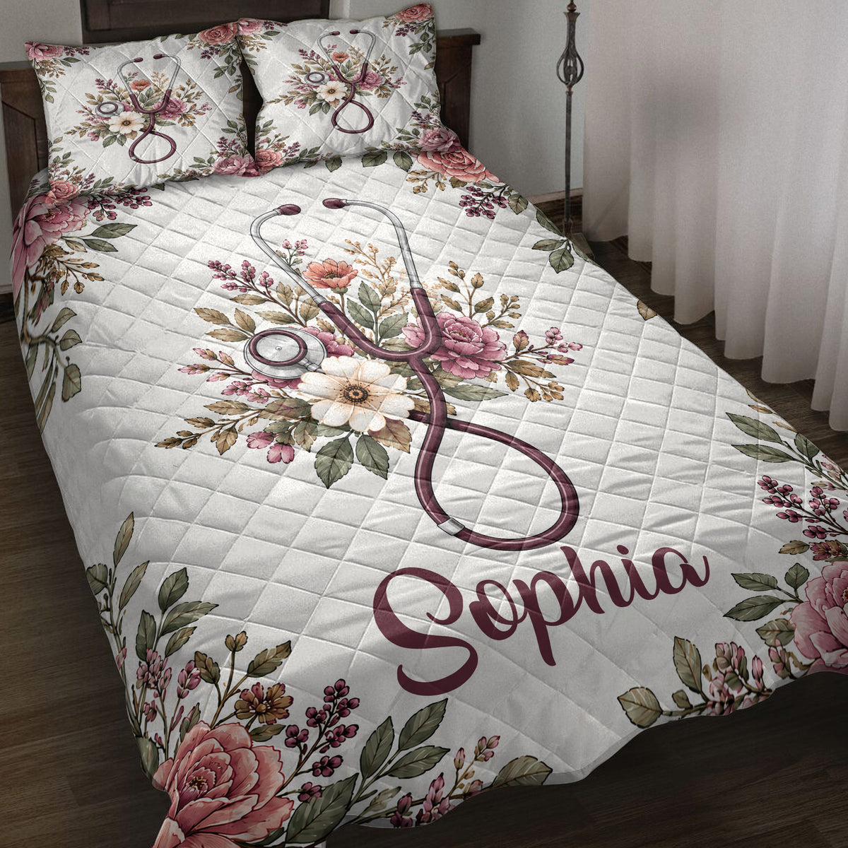 Nurse quilt blanket displayed on a bed with floral stethoscope artwork in burgundy, pink, white, and green