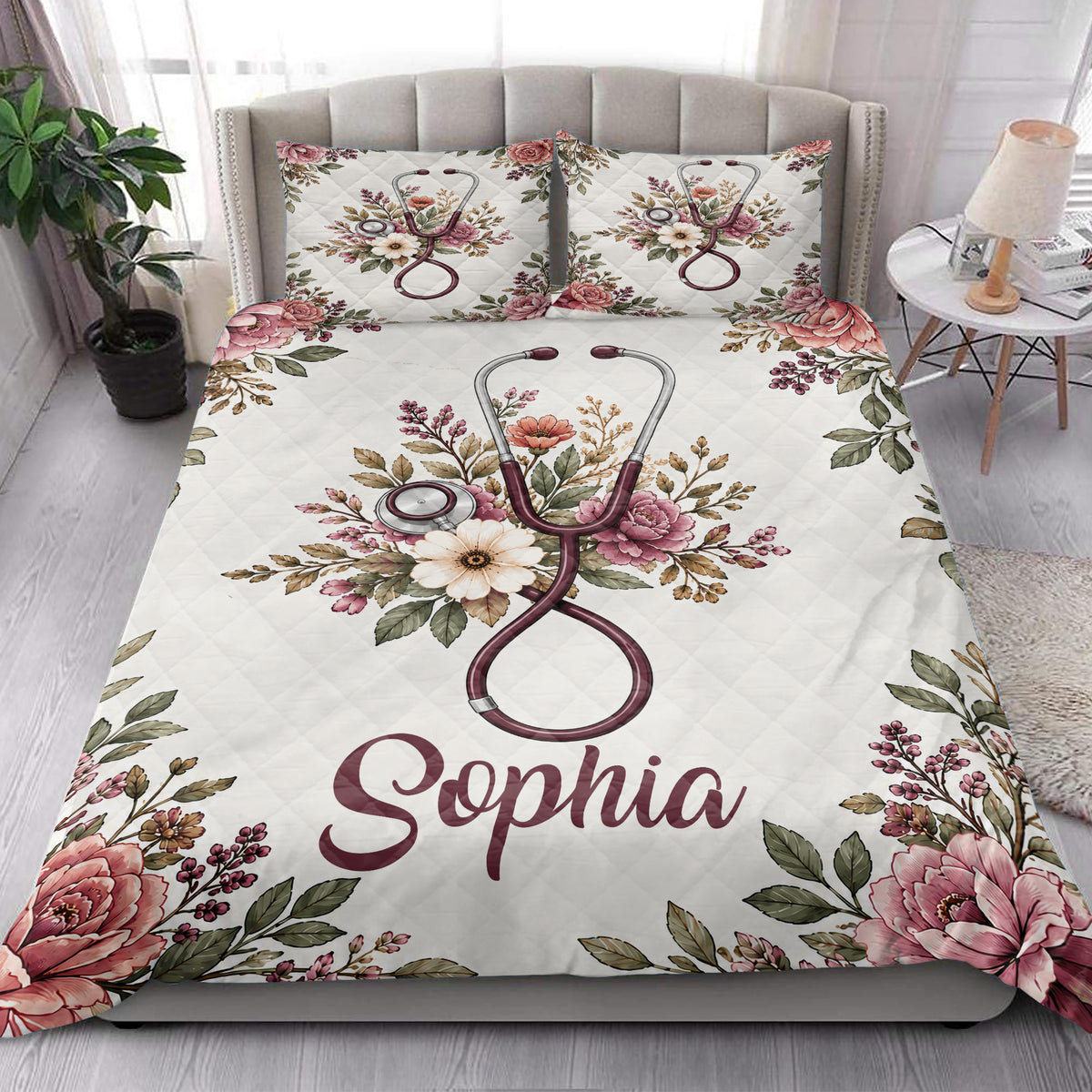 Nurse quilt blanket styled on a modern bed with floral stethoscope artwork and decorative bedroom accents