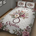 Close view of nurse quilt bedding with a burgundy stethoscope surrounded by pink and white flowers