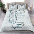 Nurse quilt blanket styled on a bed in a bright bedroom with teal medical symbols and floral stethoscope artwork
