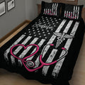 Black nurse quilt blanket displayed on a bed with stars, stripes, winged medical symbol, and pink stethoscope