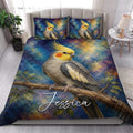 Cockatiel quilt bedding styled in a bright bedroom with a large bird perched on a branch