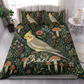 Cockatiel quilt blanket styled on a bright bedroom bed with matching bird artwork and woodland botanicals