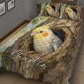 Close bedroom view of a cockatiel quilt blanket with two bird-themed pillow designs