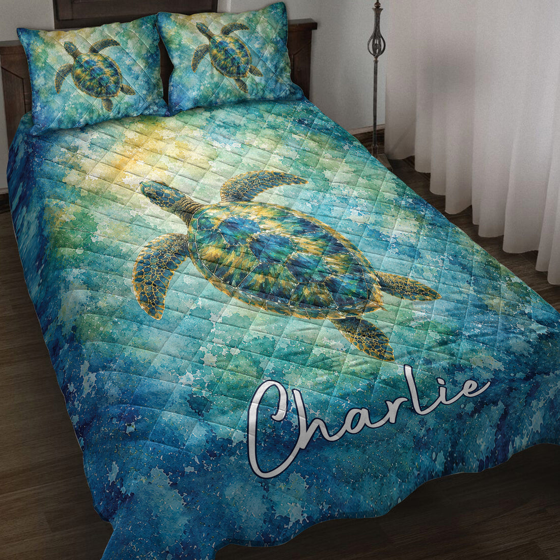 Sea turtle quilt blanket spread across a bed with vivid blue and turquoise watercolor ocean artwork