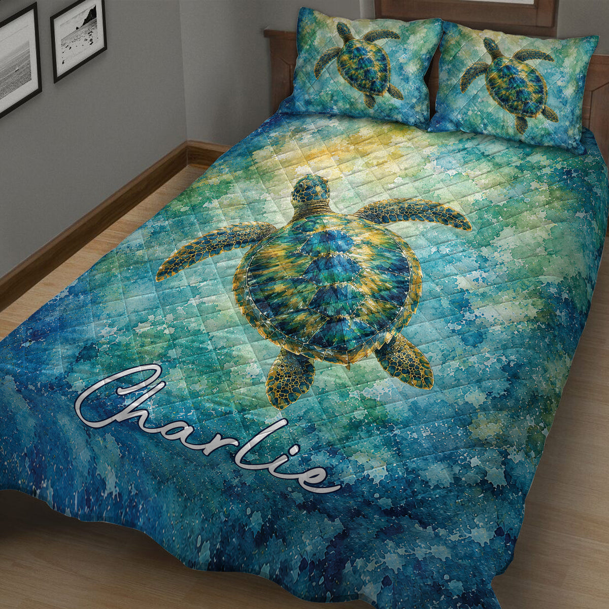 Close bedroom view of a large sea turtle on blue and green watercolor quilt bedding